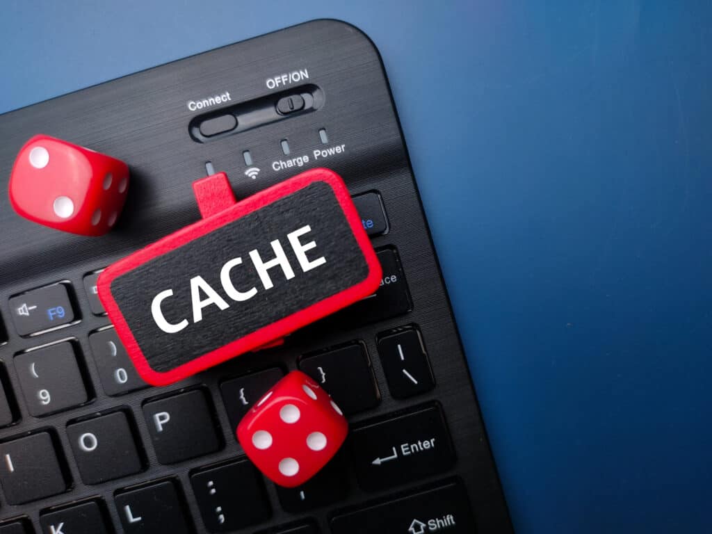 The words 'cache' and two red dice.