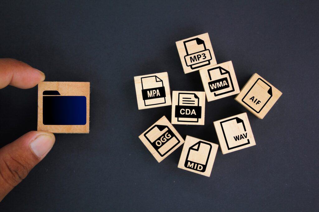 Different computer file types on small tiles or wooden pieces.
