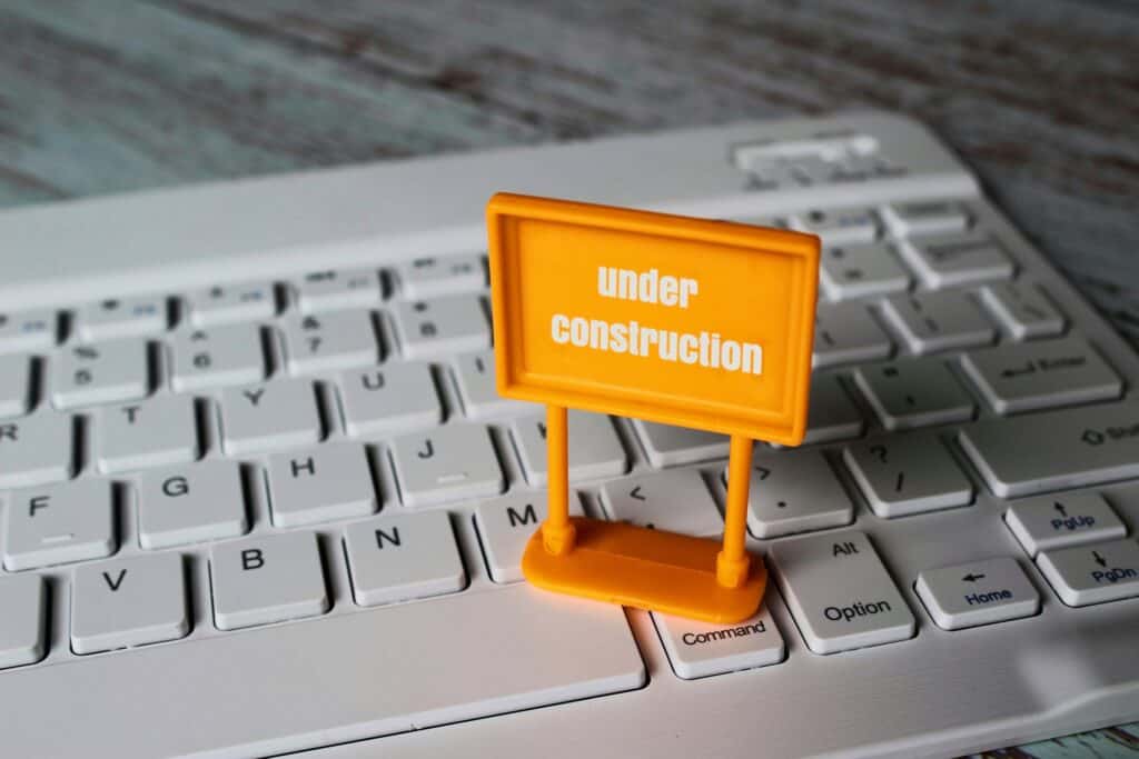 A small 'under construction' sign on a keyboard.